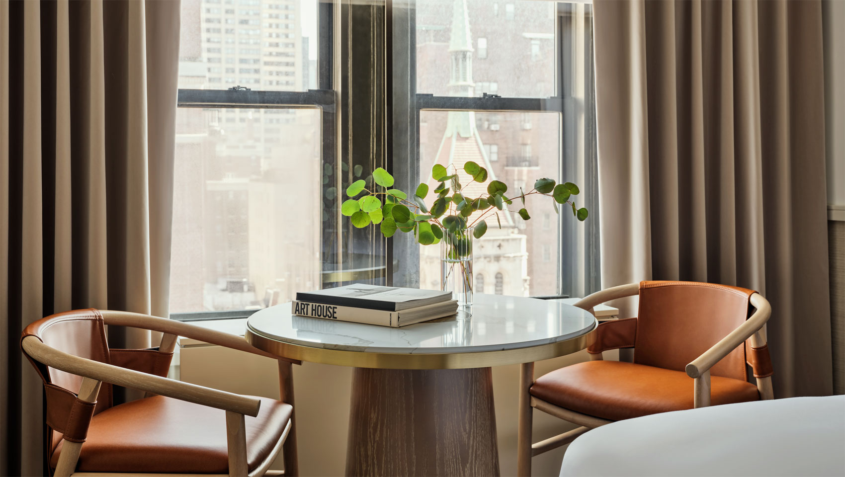 guestroom with table and chairs at 70 Park Ave