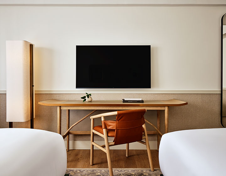 view of desk and TV in 2 queen guestroom at 70 Park Ave